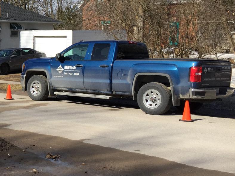 blue pickup truck used by DEMTech Services for land surveys